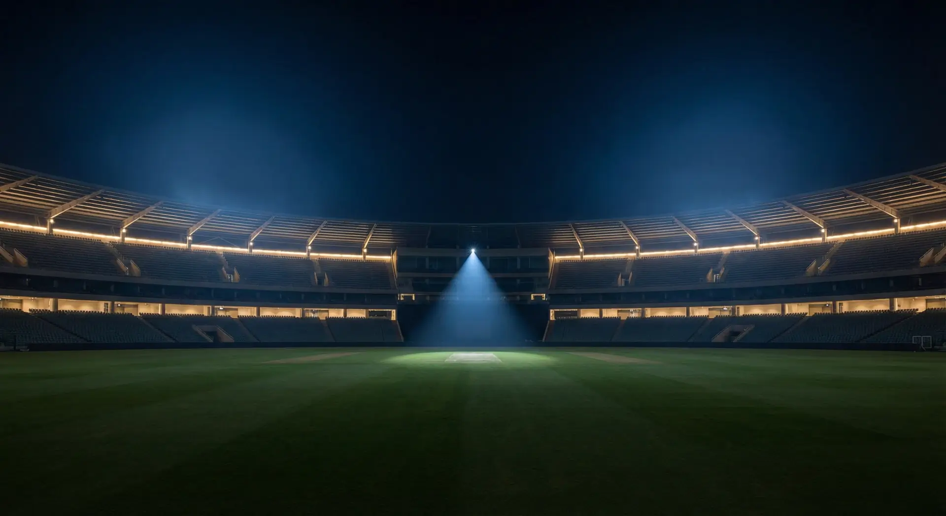 Symmetrical stadium with spotlight on empty pitch.